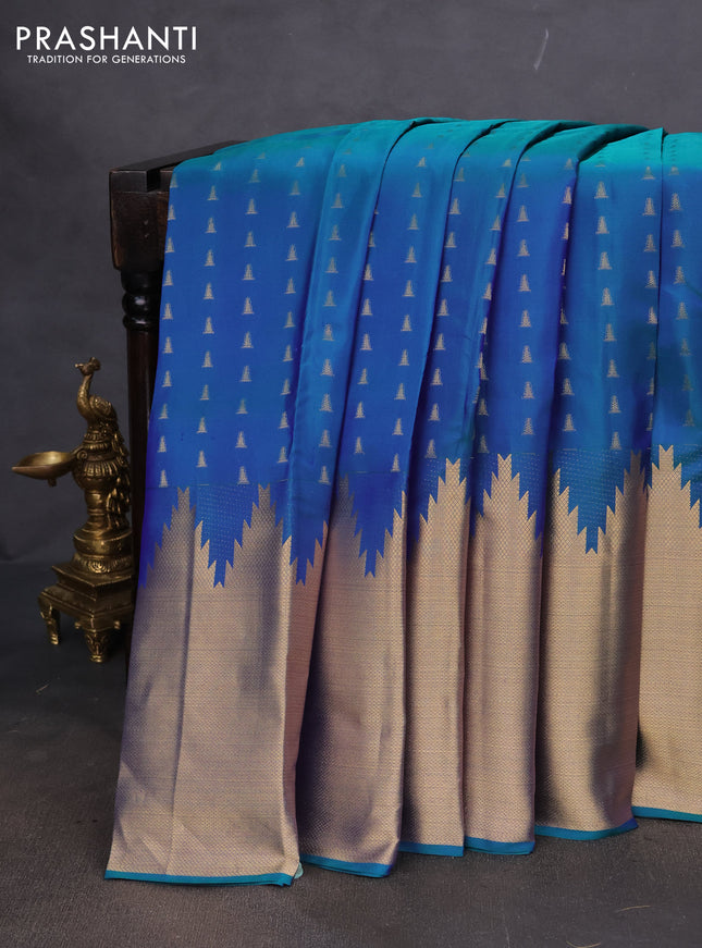 Pure kanchipuram silk saree dual shade of bluish green and pink with allover zari woven temple buttas and long temple zari woven border