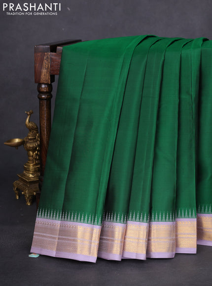 Pure kanchipuram silk saree green and pastel lavender with plain body and temple design zari woven korvai border