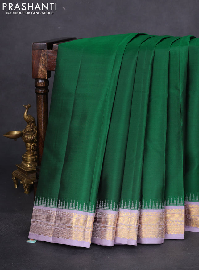 Pure kanchipuram silk saree green and pastel lavender with plain body and temple design zari woven korvai border