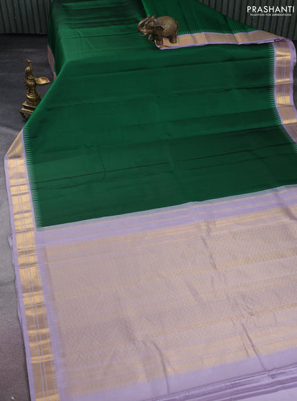 Pure kanchipuram silk saree green and pastel lavender with plain body and temple design zari woven korvai border