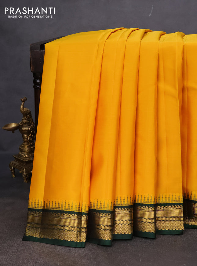 Pure kanchipuram silk saree yellow and bottle green with plain body and temple design zari woven korvai border