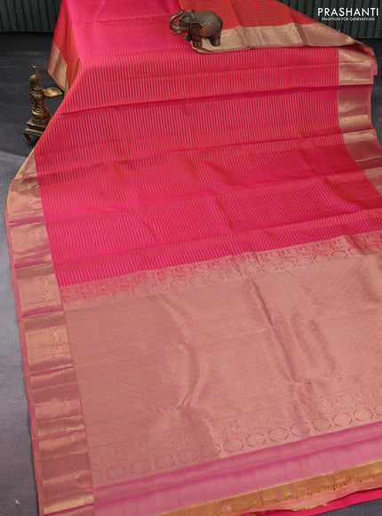 Pure kanchipuram silk saree dual shade of pinkish orange and sandal with allover zari stripe weaves and rich zari woven border