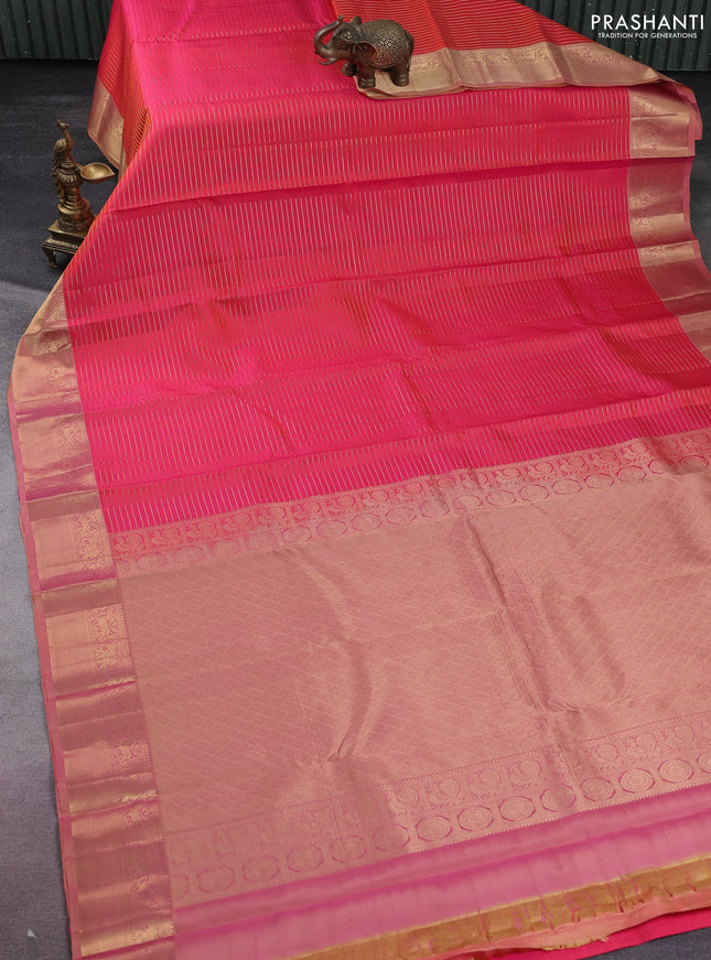 Pure kanchipuram silk saree dual shade of pinkish orange and sandal with allover zari stripe weaves and rich zari woven border