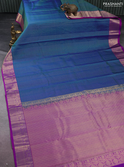 Pure kanchipuram silk saree dual shade of bluish green and purple with allover zari stripe weaves and rich zari woven border