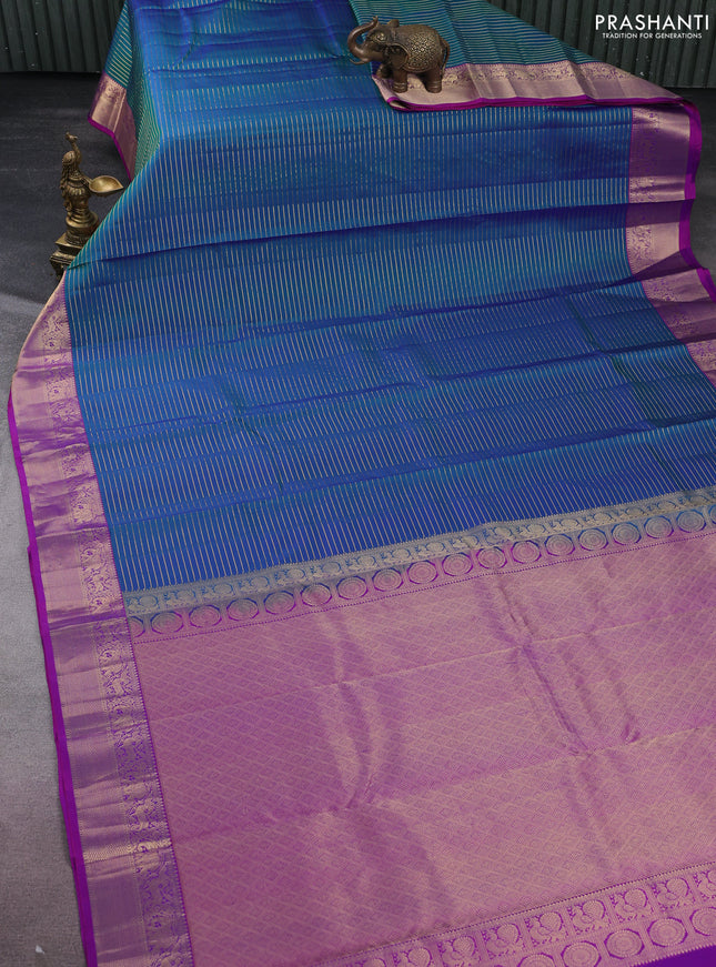 Pure kanchipuram silk saree dual shade of bluish green and purple with allover zari stripe weaves and rich zari woven border