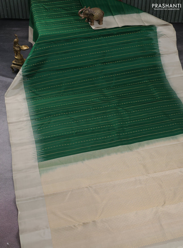 Pure kanchipuram silk saree green and beige with allover zari weaves and simple border