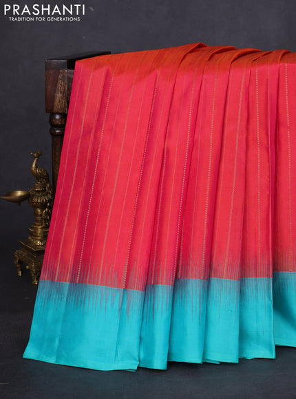 Pure kanchipuram silk saree dual shade of pinkish orange and teal blue with allover zari weaves and simple border