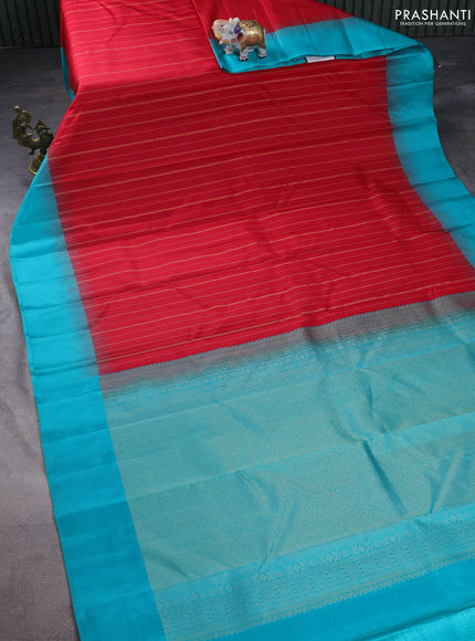 Pure kanchipuram silk saree dual shade of pinkish orange and teal blue with allover zari weaves and simple border
