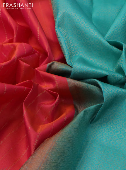Pure kanchipuram silk saree dual shade of pinkish orange and teal blue with allover zari weaves and simple border