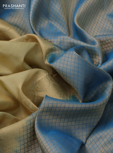 Pure kanchipuram silk saree beige and dual shade of blue with allover zari woven buttas and long rich zari woven border