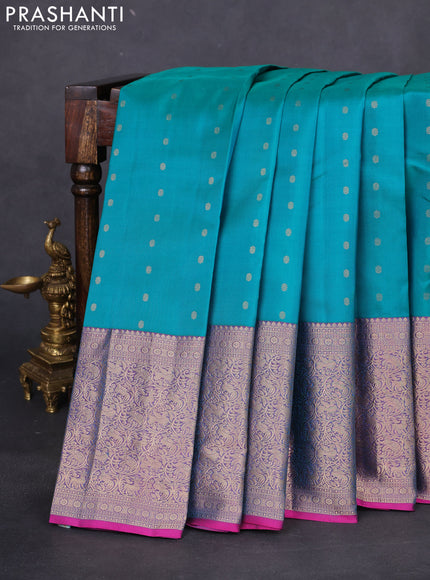 Pure kanchipuram silk saree dual shade of teal bluish green and dual shade of purple with allover zari woven buttas and long zari woven korvai border