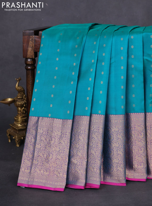 Pure kanchipuram silk saree dual shade of teal bluish green and dual shade of purple with allover zari woven buttas and long zari woven korvai border