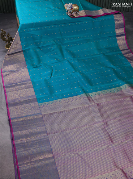 Pure kanchipuram silk saree dual shade of teal bluish green and dual shade of purple with allover zari woven buttas and long zari woven korvai border