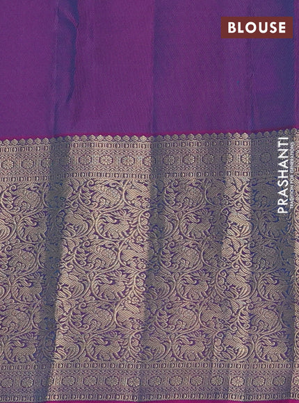 Pure kanchipuram silk saree dual shade of teal bluish green and dual shade of purple with allover zari woven buttas and long zari woven korvai border