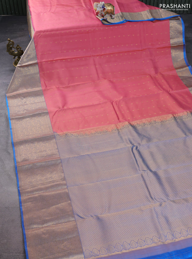 Pure kanchipuram silk saree peach shade and dual shade of blue with allover zari woven buttas and long zari woven korvai border