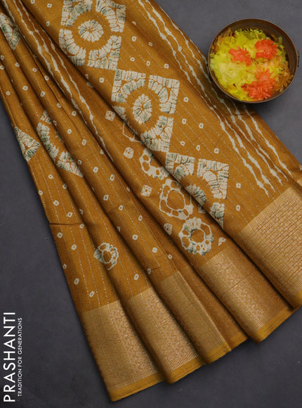 Semi dola saree mustard yellow with allover zari weaves & batik prints and zari woven border