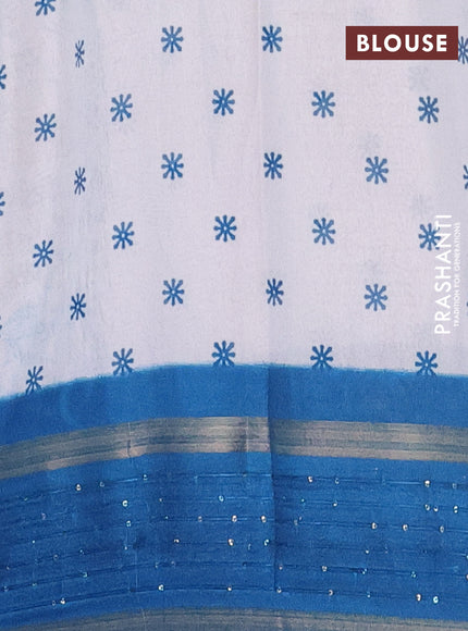 Semi dola saree off white and cs blue with allover warli prints and zari woven sequin work border