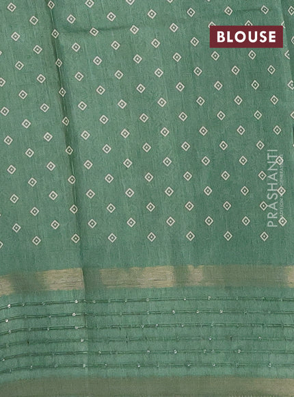 Semi dola saree pastel green with allover warli prints and zari woven sequin work border