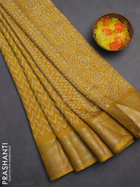 Semi dola saree yellow with allover zig zag prints and zari woven border