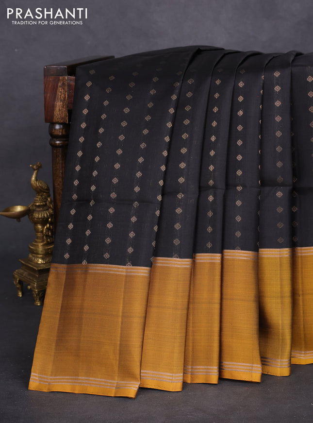 Pure soft silk saree black and dark mustard with allover zari woven buttas and long rettapet zari woven border