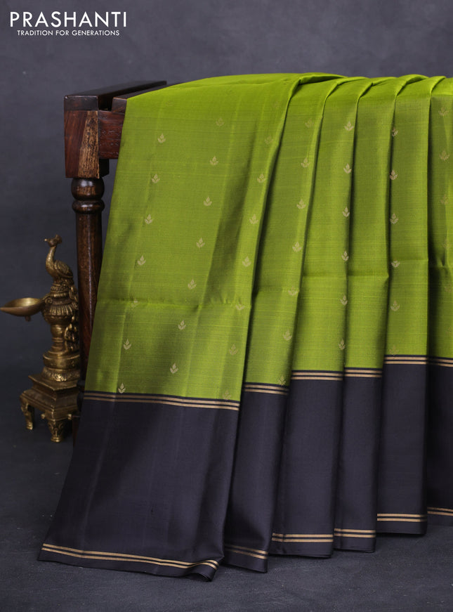 Pure soft silk saree light green and black with allover zari woven buttas and rettapet zari woven border
