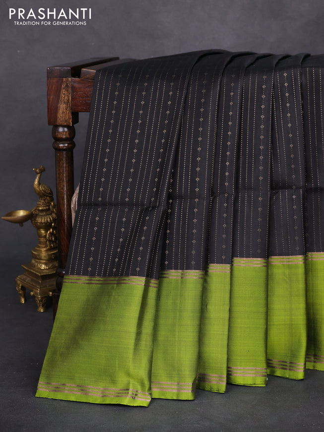 Pure soft silk saree black and light green with allover zari weaves and rettapet zari woven border