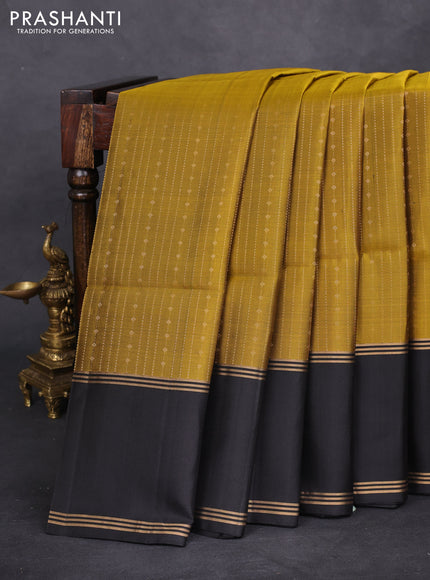 Pure soft silk saree mehendi green and black with allover zari weaves and rettapet zari woven border