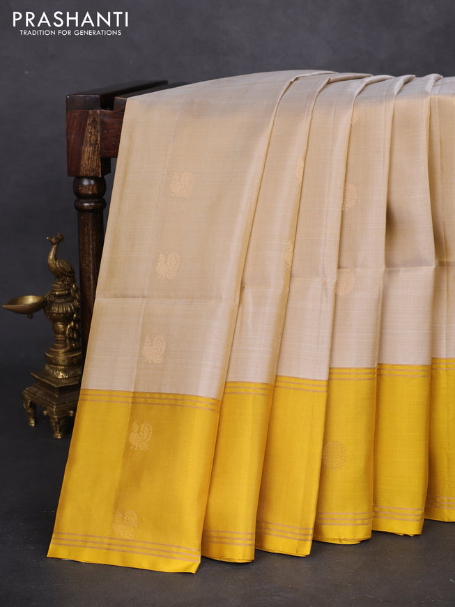 Pure soft silk saree beige and yellow with zari woven floral buttas and rettapet zari woven border