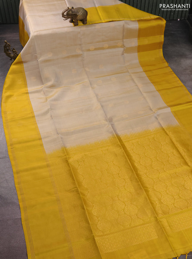 Pure soft silk saree beige and yellow with zari woven floral buttas and rettapet zari woven border