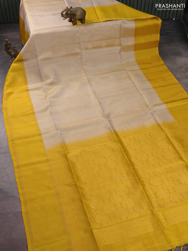 Pure soft silk saree beige and yellow with zari woven floral buttas and rettapet zari woven border