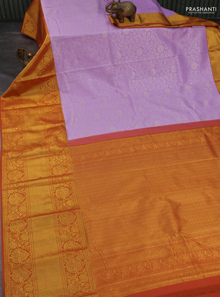 Kanchipuram silk saree lavender and rustic orange with allover zari woven brocade weaves and long rich zari woven border