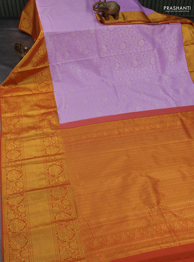 Kanchipuram silk saree lavender and rustic orange with allover zari woven brocade weaves and long rich zari woven border