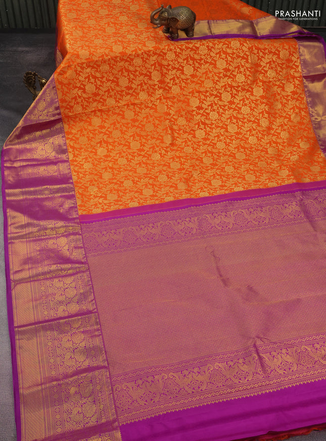 Kanchipuram silk saree orange and purple with allover zari woven floral brocade weaves and long rich zari woven border