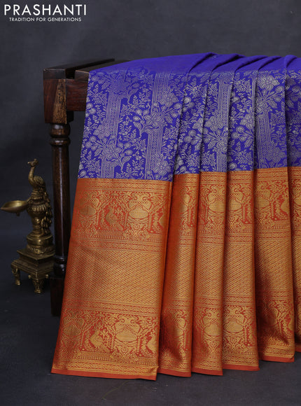 Kanchipuram silk saree blue and rustic orange with allover silver zari woven brocade weaves and long rich zari woven border