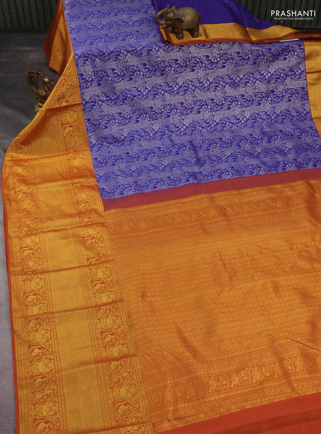 Kanchipuram silk saree blue and rustic orange with allover silver zari woven brocade weaves and long rich zari woven border