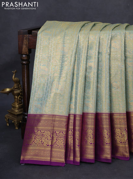 Kanchipuram tissue silk saree dual shade of teal blue and purple with allover zari woven brocade weaves and rich zari woven border