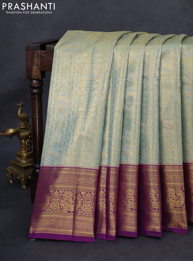 Kanchipuram tissue silk saree dual shade of teal blue and purple with allover zari woven brocade weaves and rich zari woven border