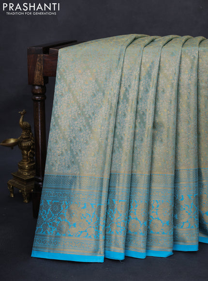 Kanchipuram tissue silk saree dual sahde of teal blue with allover zari woven brocade weaves and long rich zari woven floral border