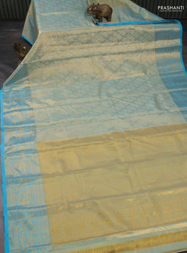 Kanchipuram tissue silk saree dual sahde of teal blue with allover zari woven brocade weaves and long rich zari woven floral border