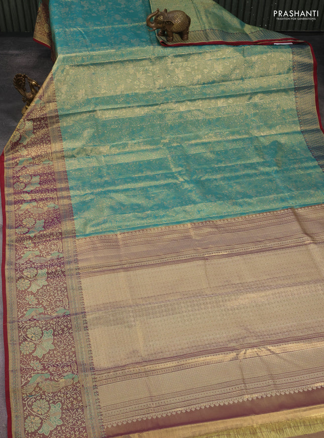 Kanchipuram tissue silk saree dual shade of teal green and maroon with allover floral zari woven brocade weaves and long rich zari woven border