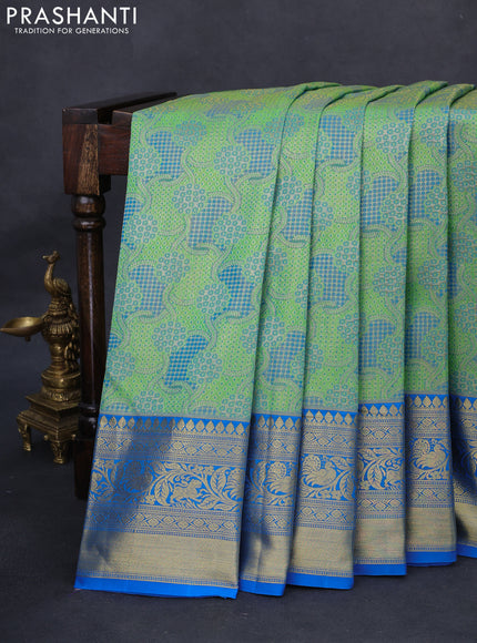 Kanchipuram tissue silk saree green and cs blue with allover zari woven brocade weaves and long rich zari woven border