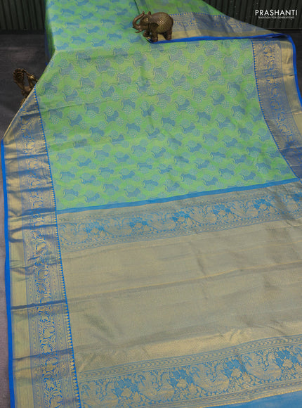 Kanchipuram tissue silk saree green and cs blue with allover zari woven brocade weaves and long rich zari woven border