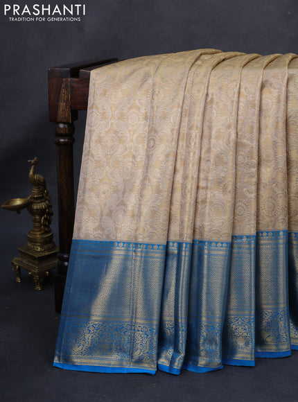 Kanchipuram tissue silk saree gold and cs blue with allover zari woven brocade weaves and long rich zari woven border