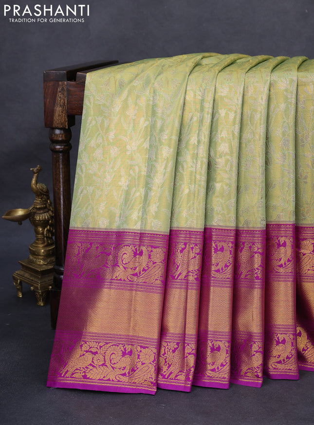 Kanchipuram tissue silk saree pista green and purple with allover zari woven floral brocade weaves and long rich peacock zari woven border