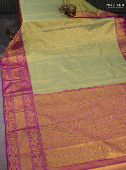 Kanchipuram tissue silk saree pista green and purple with allover zari woven floral brocade weaves and long rich peacock zari woven border
