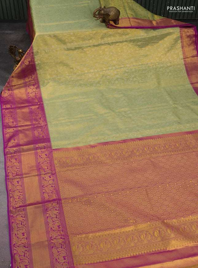 Kanchipuram tissue silk saree pista green and purple with allover zari woven floral brocade weaves and long rich peacock zari woven border