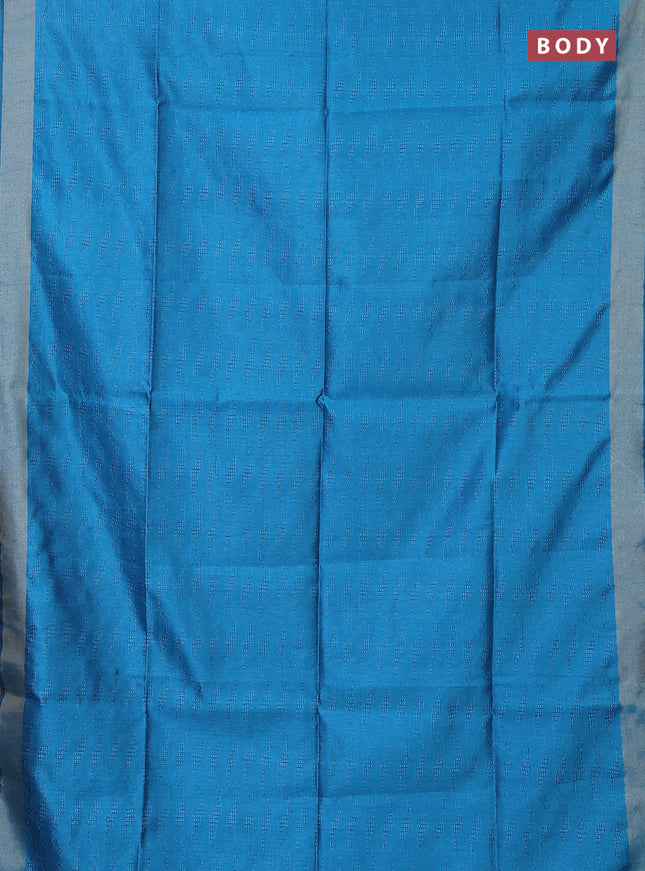 Semi dupion saree cs blue with allover self emboss and zari woven border