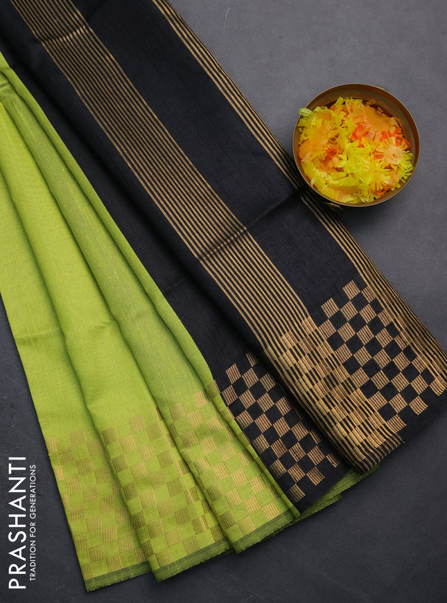 Semi dupion saree fluorescent green and black with plain body and zari woven checked border