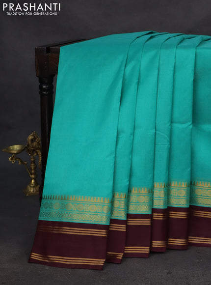Silk cotton saree teal blue and deep wine with plain body and zari woven simple border