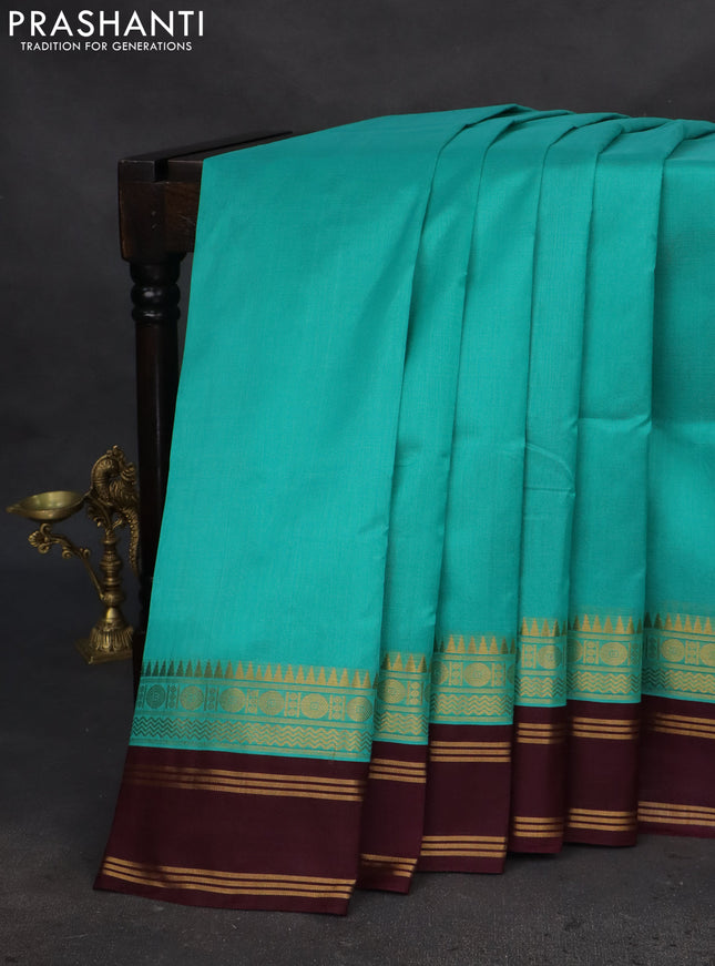 Silk cotton saree teal blue and deep wine with plain body and zari woven simple border